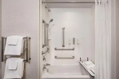 a white bathroom with a tub and a sink at Hampton Inn & Suites York South in York