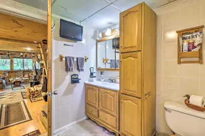 a bathroom with a sink and a toilet at Secluded and Quiet Pocono Mountain Cabin with Hot Tub! in Kunkletown
