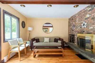 a living room with a couch and a fireplace at Sunset Estate in the Catskills in Monticello