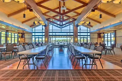 a large dining room with tables and chairs at Romantic Pocono house - stream, lake, beach, pool, firepit in Locust Lakes Village