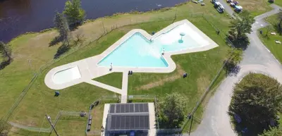 an overhead view of a swimming pool on top of a house at Peaceful Pocono Lakefront, beach, pools, firepit, pets in Arrowhead Lake