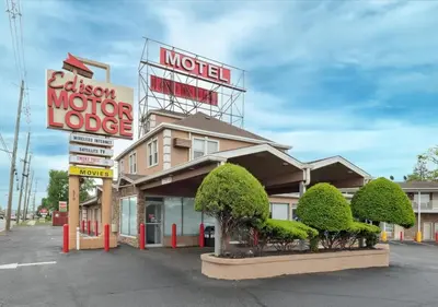 a motel with a sign for a motor lodge at Edison Motor Lodge in Edison