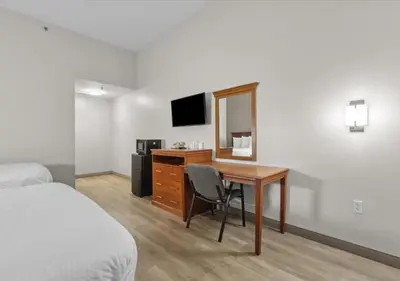 a hotel room with a desk and a television at Edison Motor Lodge in Edison
