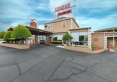 an empty parking lot in front of a motel at Edison Motor Lodge in Edison