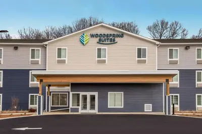 a westinghouse suites building with a sign on it at WoodSpring Suites South Brunswick - Princeton in Monmouth Junction