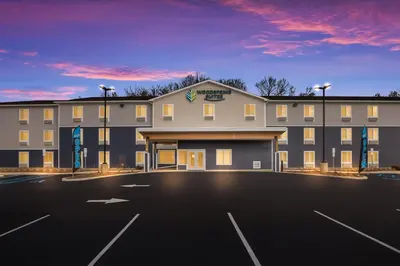a rendering of a hotel with a parking lot at WoodSpring Suites South Brunswick - Princeton in Monmouth Junction