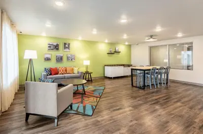 a living room with a couch and a table at WoodSpring Suites South Brunswick - Princeton in Monmouth Junction