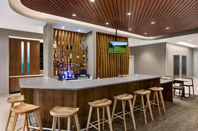 a bar with stools in a hotel lobby at SpringHill Suites by Marriott Camp Hill in Camp Hill