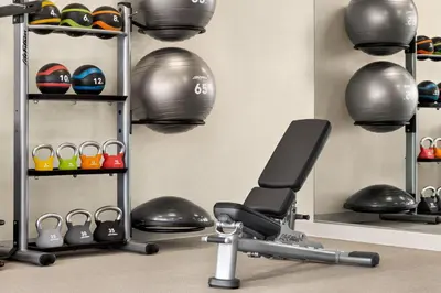 a room with a gym with weights and balls at SpringHill Suites by Marriott Camp Hill in Camp Hill