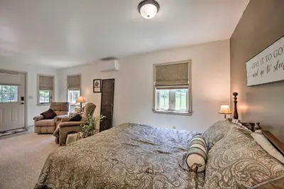 a bedroom with a large bed and a living room at Cozy Garden Room in Welsh Mountain Suites! in New Holland
