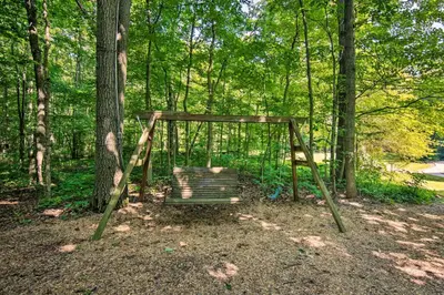 a swing set in the middle of the woods at Cozy Garden Room in Welsh Mountain Suites! in New Holland