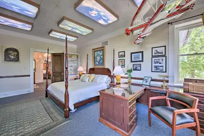 a master bedroom with a bed and a desk and a desk at 8 Mi to Hersheypark Millard Mansion in Annville in Annville