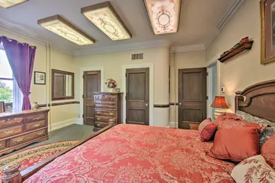 a bedroom with a large bed with a red bedspread at 8 Mi to Hersheypark Millard Mansion in Annville in Annville