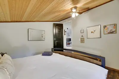 a bedroom with a white bed with a wooden ceiling at Pet Friendly Ski Retreat in Lake Community in Locust Lakes Village