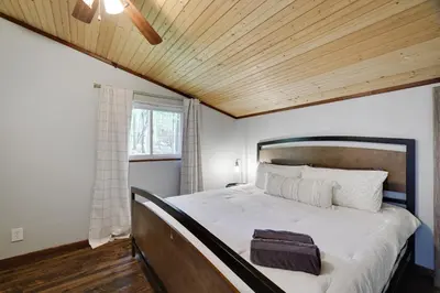 a bedroom with a large bed with a wooden ceiling at Pet Friendly Ski Retreat in Lake Community in Locust Lakes Village