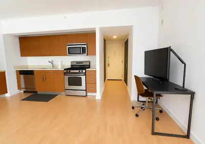 a kitchen with a desk with a television on it at Studio apart Time Square in New York