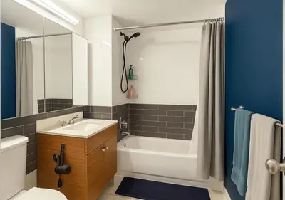 a bathroom with a tub and a sink and a toilet at Studio apart Time Square in New York