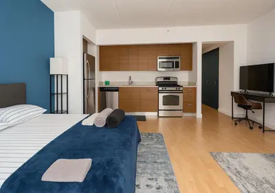 a large room with a bed and a kitchen at Studio apart Time Square in New York