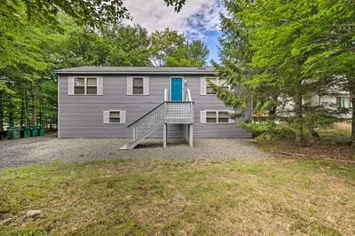 a house with a staircase in front of it at Furnished Deck and Lake Access Poconos Place! in Tobyhanna