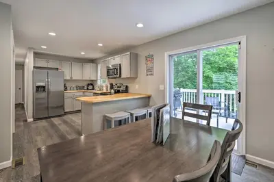 a kitchen and dining room with a table and chairs at Furnished Deck and Lake Access Poconos Place! in Tobyhanna