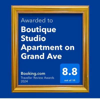 an invitation to a boutique studio appointment on grand avenue in a gold frame at Boutique Studio Apartment on Grand Ave in Englewood
