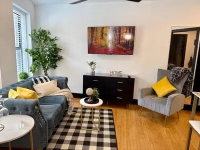 a living room with a couch and two chairs at Boutique Studio Apartment on Grand Ave in Englewood