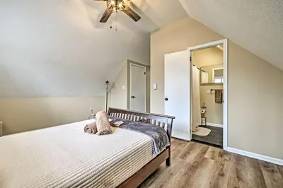 a bedroom with a bed with a cat laying on it at Golf, Ski and Fish Cabin with Deck in Tobyhanna! in Tobyhanna