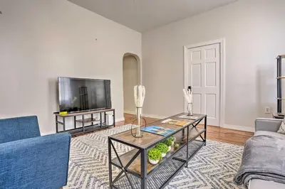 a living room with a table and a tv at Updated Bayonne Townhome about 11 Mi to NYC! in Bayonne