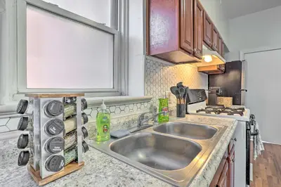 a kitchen with a sink and a stove at Updated Bayonne Townhome about 11 Mi to NYC! in Bayonne