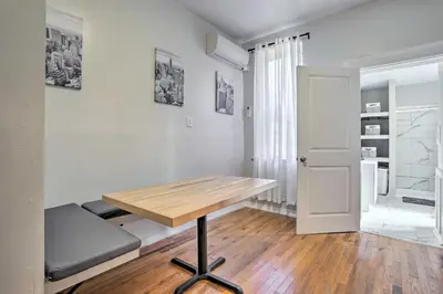 a room with a wooden table and a bench at Updated Bayonne Townhome about 11 Mi to NYC! in Bayonne