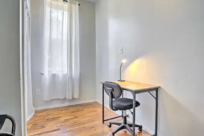 a desk and a chair in a room with a window at Updated Bayonne Townhome about 11 Mi to NYC! in Bayonne