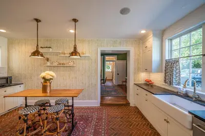 a kitchen with a table and some chairs in it at The Walton House - historic 3bd 2 5ba with parking in Kennett Square