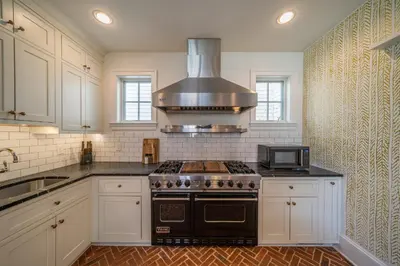 a kitchen with a stove and a microwave at The Walton House - historic 3bd 2 5ba with parking in Kennett Square