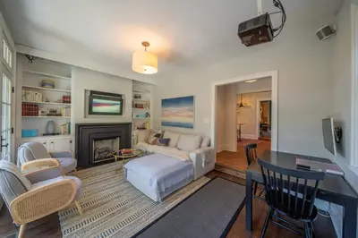 a living room with a couch and a fireplace at The Walton House - historic 3bd 2 5ba with parking in Kennett Square