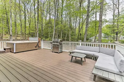 a deck with a couch and a barbecue and a grill at Updated Stroudsburg Home with Spacious Deck! in Stroudsburg