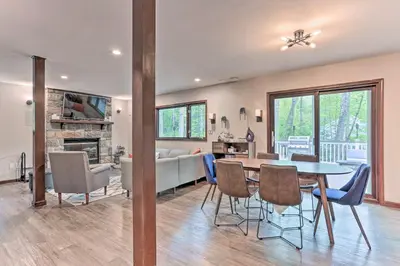 a dining room and living room with a table and chairs at Updated Stroudsburg Home with Spacious Deck! in Stroudsburg