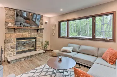 a living room with a couch and a fireplace at Updated Stroudsburg Home with Spacious Deck! in Stroudsburg