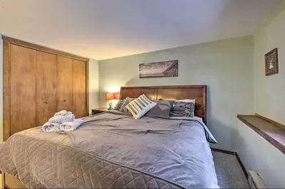 a bedroom with a large bed with a wooden headboard at Ian's Camelback House in Tannersville