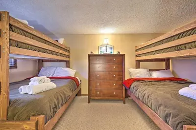 two beds in a bedroom with two bunk beds at Ian's Camelback House in Tannersville