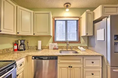 a kitchen with white cabinets and a stainless steel refrigerator at Ian's Camelback House in Tannersville