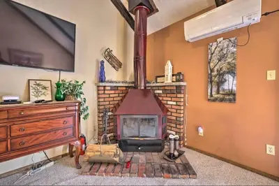 a brick fireplace in a living room with a tv at Ian's Camelback House in Tannersville
