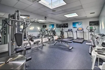 a gym with several tread machines in a room at Garrett's Camelback House in Tannersville