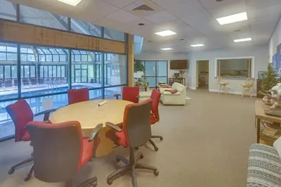 a conference room with a table and chairs and a pool at Garrett's Camelback House in Tannersville