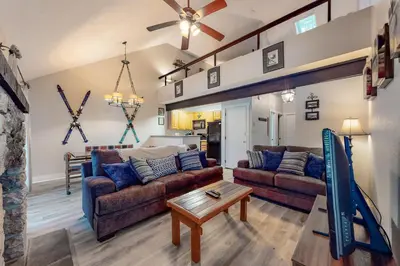a living room with two couches and a table at Unwind in Telstar in Lake Harmony