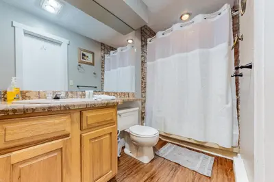 a bathroom with a toilet and a sink and a shower at Unwind in Telstar in Lake Harmony