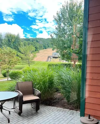 a patio with a table and a chair and a table at Mountain Creek Resort at Appalachian Hotel - Pool & Hot Tub in Vernon Township