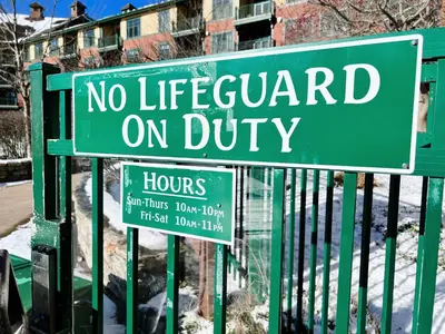 a green sign that says no lifeguard on duty at Mountain Creek Resort at Appalachian Hotel - Pool & Hot Tub in Vernon Township