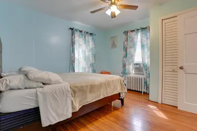 a bedroom with a bed and a ceiling fan at 11 Mi to Manhattan Pet-Friendly Duplex with Yard! in Teaneck