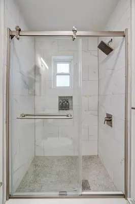 a shower with a glass door in a bathroom at Luxurious 2BD family friendly, central in Philadelphia