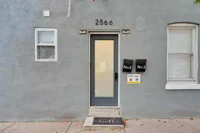 a gray building with a door and two windows at Luxurious 2BD family friendly, central in Philadelphia